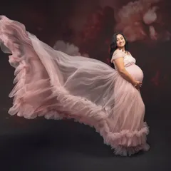 Feeling like a queen in this breathtaking pink maternity gown. This shot captures the essence of grace and the joy of motherhood, with a flowing train that feels like a dream.