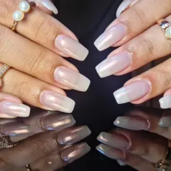 A close-up of the sheer, pearly white polish, showing its subtle shimmer and flawless application.
