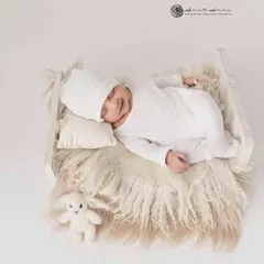 Simplicity at its finest. An all white setup with a cozy knit outfit and a tiny bunny friend creates a pure, timeless, and angelic newborn portrait.