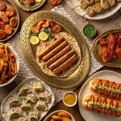 A full spread of plant-based products from Blue Tribe. This shot showcases the incredible variety of their offerings, from kebabs and momos to hot dogs and nuggets, proving that plant-based can be plentiful.