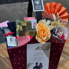 Celebrating the groom-to-be with a hamper designed just for him. This basket includes a mix of his favorite things, from luxury chocolates to personalized items, all styled to honor his big day.