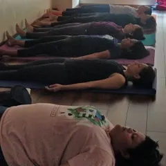 A line of mothers-to-be resting in Savasana, the final and most important pose. This is where the body heals, the mind quiets, and you connect with your baby in perfect stillness.