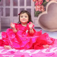 A vision in pink. This little girl is all smiles in her beautiful dress, surrounded by Barbie-themed props in our custom studio setup.