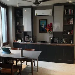 A glimpse into a luxury office interior we handed over. This space features a large conference table, comfortable seating, and extensive custom bookshelves.