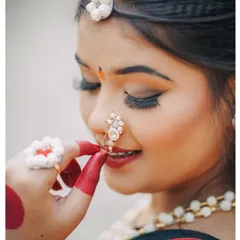 A close-up shot focusing on the delicate details of the 'halwyache dagine' (sugar ornaments) and nath worn for Makar Sankranti.
