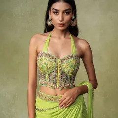 A detailed shot of a modern ethnic top. The pose is designed to highlight the corset-style bustier and the delicate embellishments, giving customers a clear view of the product's features.