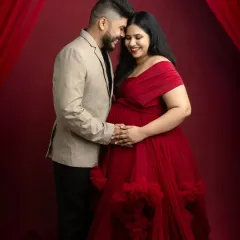 An intimate moment during the elegant gown session. This pose, with the couple close together, focuses on their connection and the shared joy of their pregnancy journey.