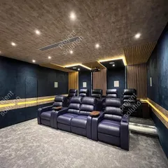 This project showcases a complete home theater solution with luxurious, two-tiered navy blue motorized recliners. The design integrates wood slat panels and dark blue fabric for superior room acoustics and a sophisticated aesthetic.
