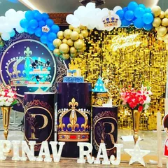 For a royal celebration, this Prince theme uses a rich color palette of blue and gold. I created a stunning main stage with a gold shimmer wall, custom backdrops with crown motifs, themed cake plinths, and marquee letters spelling out the birthday boy's name.