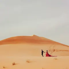A grand, sweeping view of the Dubai desert. I positioned the couple to emphasize the vastness of the landscape, creating an epic and dramatic pre-wedding photograph.