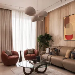 Soft tones and sculptural forms create effortless warmth in this living room. I brought together fluted wood panels, cozy textures, and organic curves to design a space that feels calm, modern, and deeply lived-in.