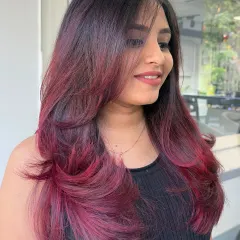 A beautiful portrait of the client, her smile radiating as much as her new vibrant hair color.