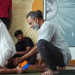 Yoga is a journey within. Here, Srinatha Sir provides a hands-on adjustment to a student in an inversion, ensuring safe alignment and deeper expression of the pose.