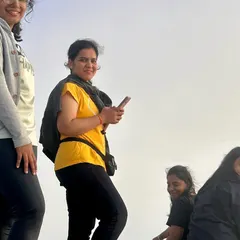 Trekkers enjoying the view from the top of Uttari Betta. It's a great spot for photos and quiet reflection.
