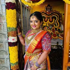 A happy smile from a bride on her special day. I love how the intricate, multi-colored threadwork on her blouse sleeves stands out against her beautiful silk saree.