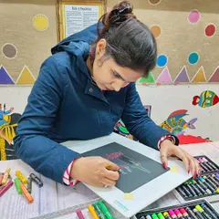 A student working on her oil pastel drawing. Our classes provide a comfortable setting to practice and refine your skills with guidance from our instructors.