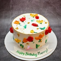 A bright and cheerful floral cake for a mother's birthday. I used a palette knife painting technique with buttercream to create these colourful, abstract flowers.