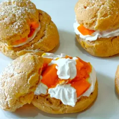 These are my Mango Cream Puffs, a perfect bite of summer. The light, airy choux pastry is filled with a delicate cream and chunks of sweet, fresh mango.