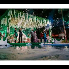 The perfect party shot. The couple on a stage over the pool, champagne popping, and fireworks lighting up the sky. This is a celebration captured in all its glory.