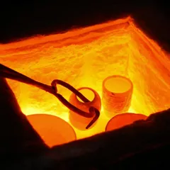 A view inside the kiln, where the pottery pieces are glowing red-hot at around 1000 degrees Celsius, just before being removed for post-firing reduction.