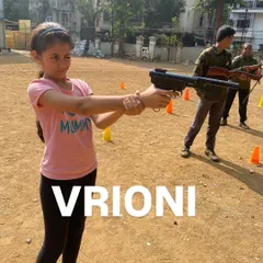 Vrioni confidently holds her stance, ready to take her shot at the target.