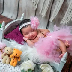 A little ballerina in the making. This adorable setup with a pink tutu and floral headband is perfect for capturing a sweet, girly vibe.