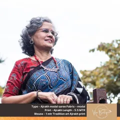 A graceful client wearing a beautiful Ajrakh modal saree. The traditional print and earthy colors look absolutely stunning on her, and she has paired it with a lovely beaded necklace.