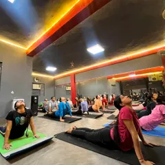 The energy in our group classes is incredible. Here you can see students of different levels moving together in Bhujangasana (Cobra Pose), building back strength and opening their hearts in our Sagar Pur studio.
