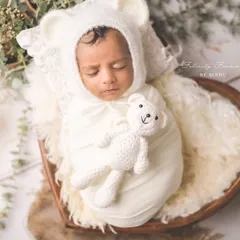 So tiny, so new, so loved. This little one is peacefully dreaming, cuddled up with a tiny teddy bear, a perfect portrait of newborn innocence. I use soft textures and props to keep your baby cozy.