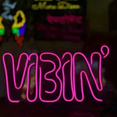 A fun 'VIBIN' neon sign in bright pink, perfect for a Sangeet, cocktail party, or a cool photo booth.