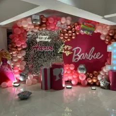 We brought the popular Barbie theme to life for this first birthday party. The decoration features a stunning pink balloon arch, a silver sequin wall for extra sparkle, multiple neon signs, and custom Barbie-themed props, creating a glamorous and fun party setting.