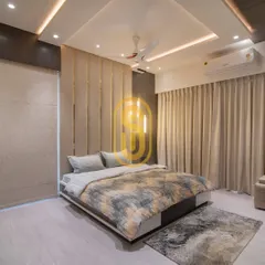 A wider view of the bedroom with the upholstered feature wall, showing the custom bed and matching area rug. The design includes both sheer and blackout curtains for complete light control.
