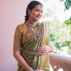 This mom-to-be is glowing in her green Kanchivaram saree for her Seemantham ceremony. I designed a custom gold embroidered blouse to add a touch of radiance to her look.