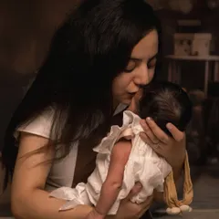 A mother's gentle kiss for her newborn. These are the quiet, heartfelt interactions that I aim to preserve, creating timeless images of maternal love.