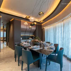 A closer view of the dining area at Lodha World View, where the design reflects the family’s love for fine living. Illuminated by soft, ambient lighting from the sculptural pendants, the space fosters an inviting atmosphere for intimate dinners and lively gatherings.