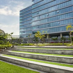 Tiered landscape seating at the Godrej Centre Development provides an outdoor amphitheater for employees. This feature encourages informal gatherings and relaxation, extending the workspace into the natural environment.