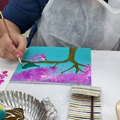Feel the brush in your hand and watch the colors come to life. This is a close up from our cherry blossom painting session, where we guide you through each step to create a beautiful piece of art. It's a therapeutic experience, perfect for unwinding and focusing your creativity.