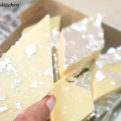 A close up of my homemade Kaju Katli, decorated with edible silver leaf. I make this classic sweet with a smooth texture and the perfect level of sweetness, ensuring it tastes just like it should.