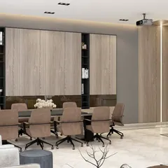 This conference room features extensive built-in storage and a large meeting table, set against a backdrop of marble and wood panels for a sophisticated look.