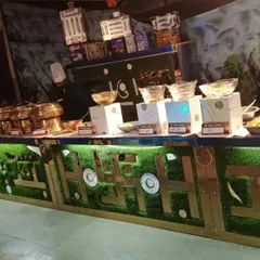 The same custom-designed counter, now fully stocked with food and manned by my chefs. This shows how a themed counter integrates seamlessly into the event service.