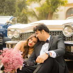 A romantic moment with a vintage Cadillac. The combination of classic formalwear, a beautiful vintage car, and the soft, warm tones creates a dreamy, nostalgic, and incredibly stylish pre-wedding photograph.