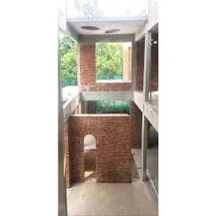 The bones of an old building hold its memory. In this Coimbatore home restoration, we revealed the original brick arches and concrete frame, creating a dramatic, light filled core that honors the structure's past.