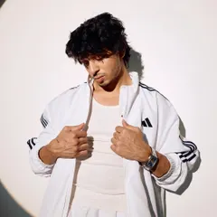 An unseen shot from my 2025 press kit. The all-white Adidas tracksuit and spotlight effect create a clean, athletic, and ambitious vibe.