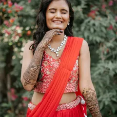 A moment of pure joy. This bride's happy expression says it all, as she shows off her full-arm bridal mehendi.