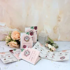 A closer look at the beautiful floral design and glitter details on my custom wedding itineraries.