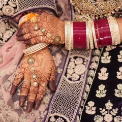 The beautiful contrast of a dark henna stain against a bride's ornate lehenga and bangles. This is the classic bridal look so many people love.