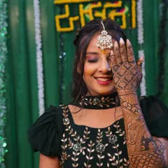 A classic bridal pose, highlighting the intricate design on the back of the hand. The dense pattern covers the entire hand and wrist for a complete look.