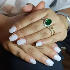 The 'milky nails' trend is popular for its clean and subtle look. This is a semi-sheer white polish that gives a fresh, healthy, and polished appearance to the nails.