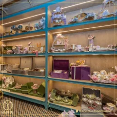 The display shelves at our Ahmedabad store, showcasing a wide array of our gift hampers and decorative items. The color-coded sections help clients easily navigate our collections.