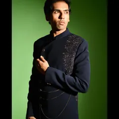 The angrakha style cut of this Indo western jacket is a modern interpretation of a classic silhouette. It is tailored to create a flattering, slim profile while allowing for comfortable movement.